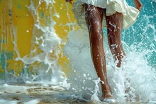 a person's legs in a white dress splashing water