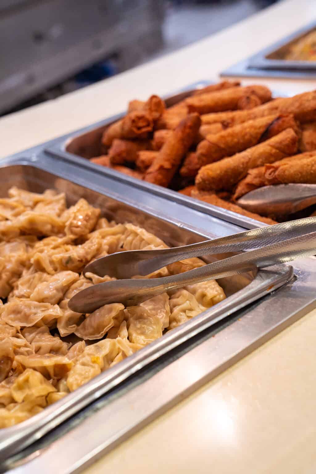 a tray of food with tongs