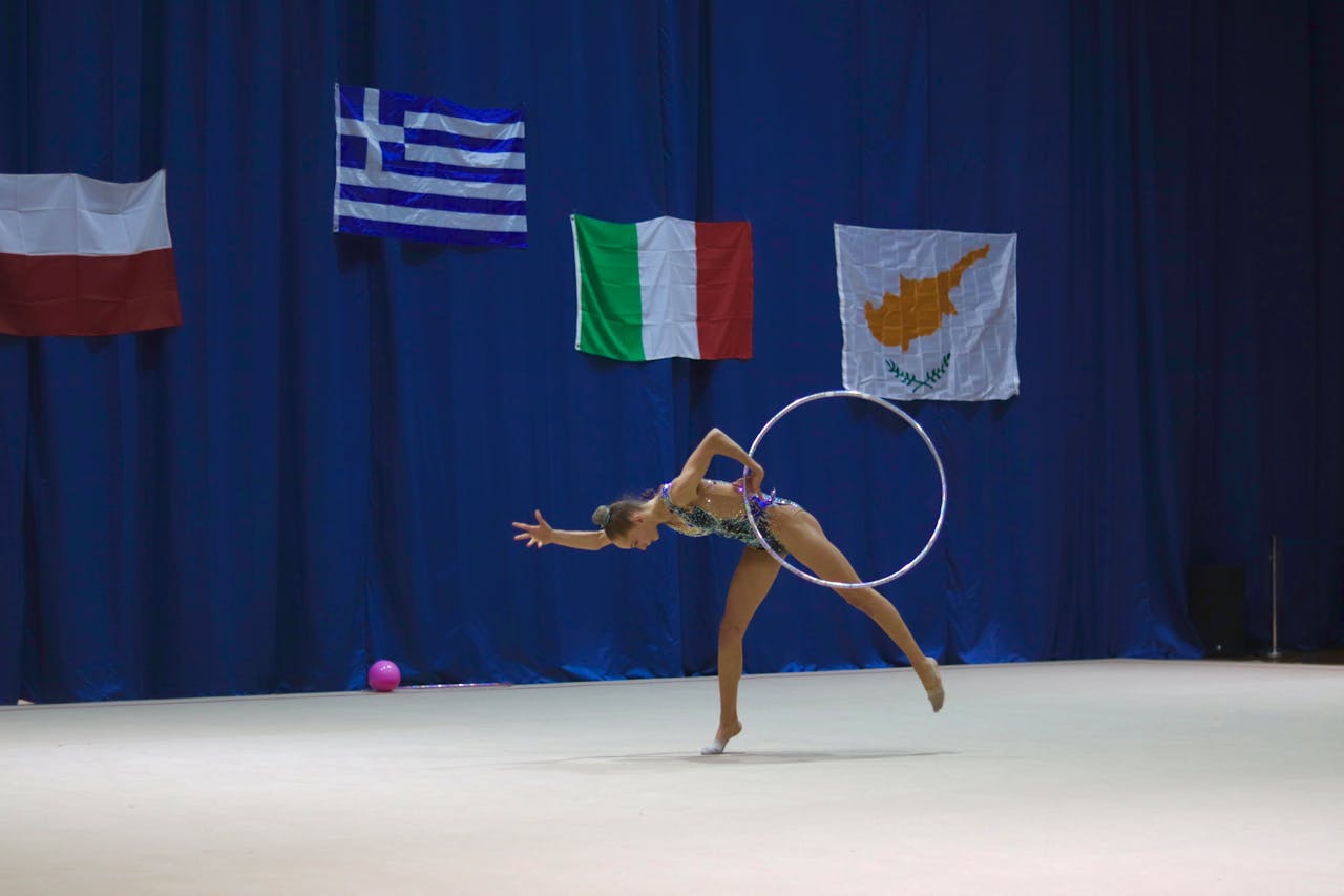 a woman in a leotard with a hoop