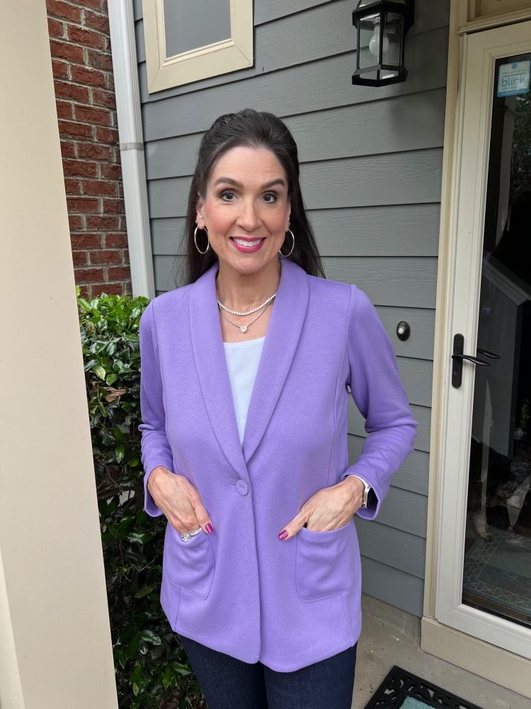 a woman in a purple suit