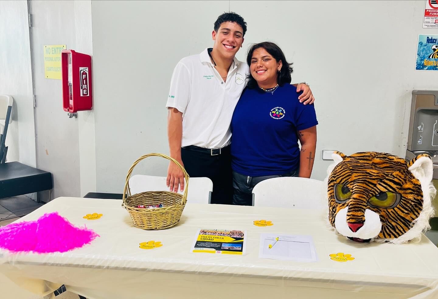 a man and woman standing next to a table with a tiger head