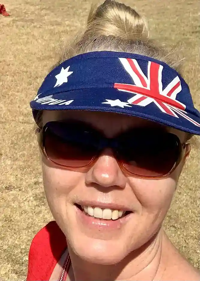 a woman wearing sunglasses and a blue visor