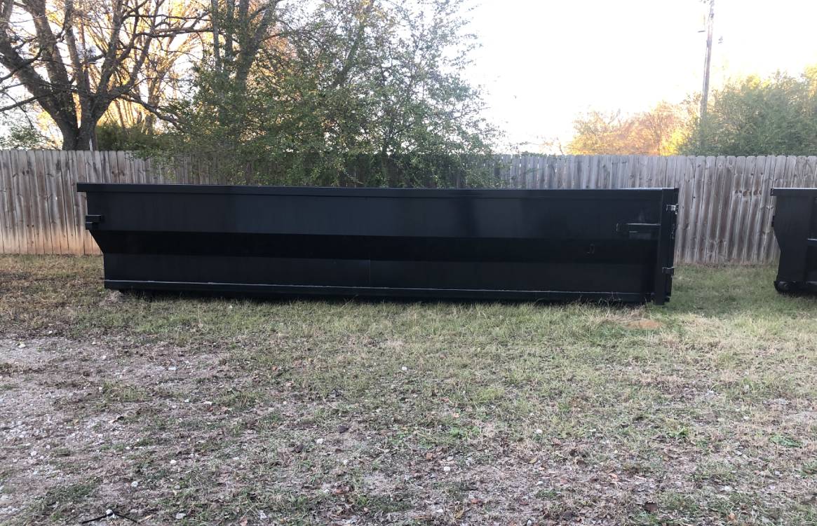 a black metal container in a yard