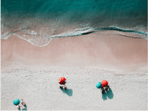 a group of people on a beach with umbrellas