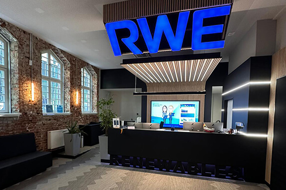 a blue sign above a black reception desk