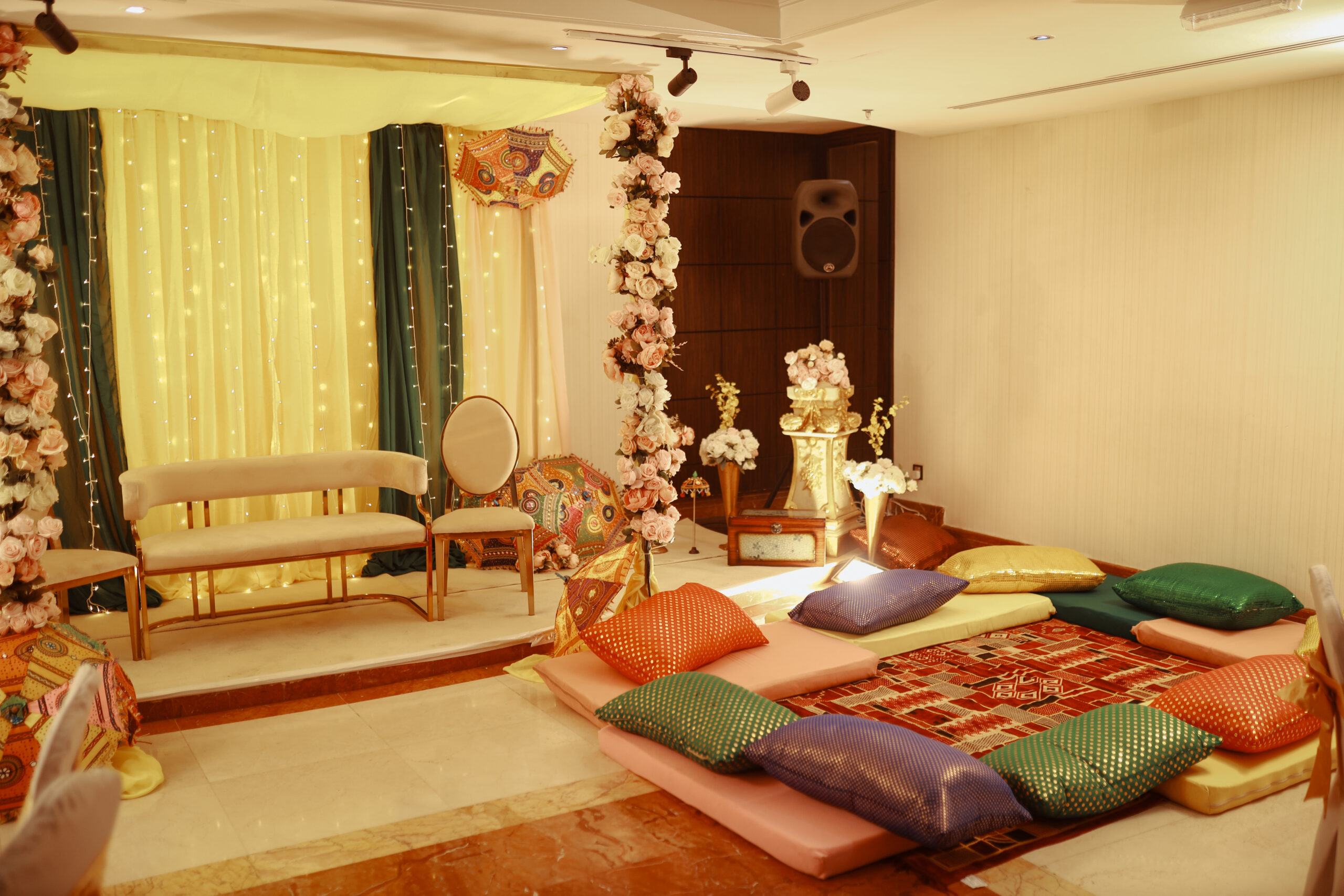 a room with colorful pillows and a flower arrangement
