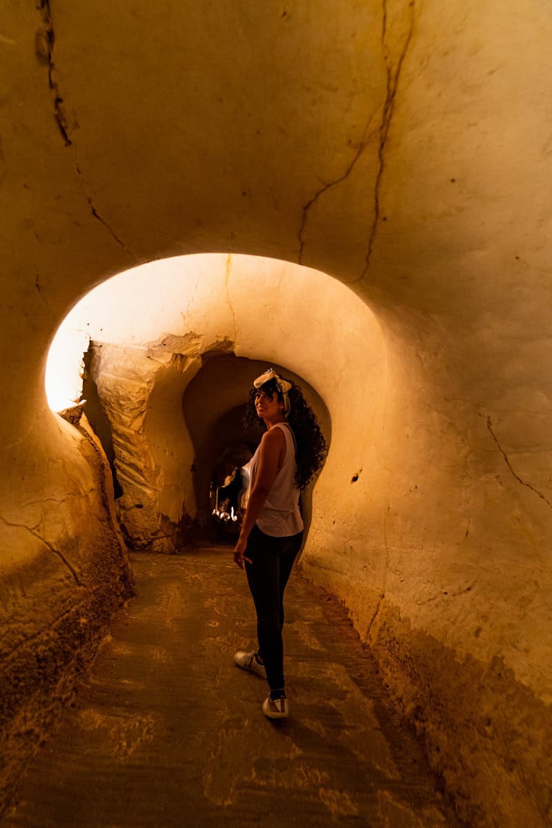 a woman standing in a tunnel