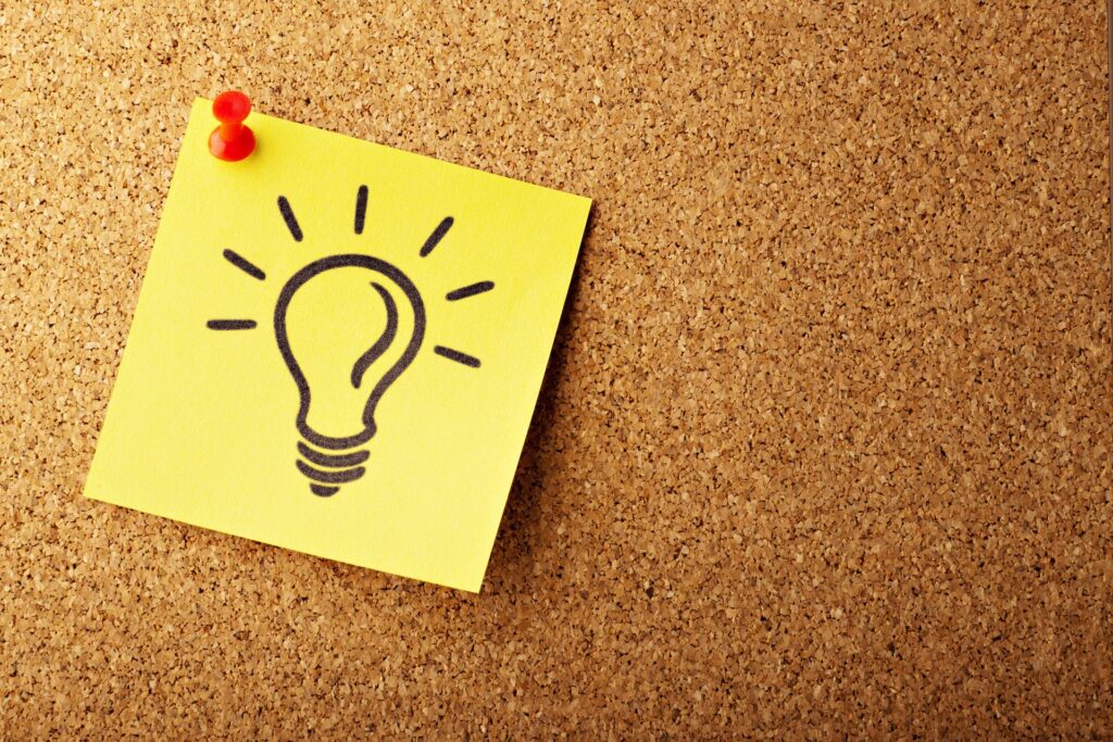 a yellow post-it note with a light bulb drawn on it