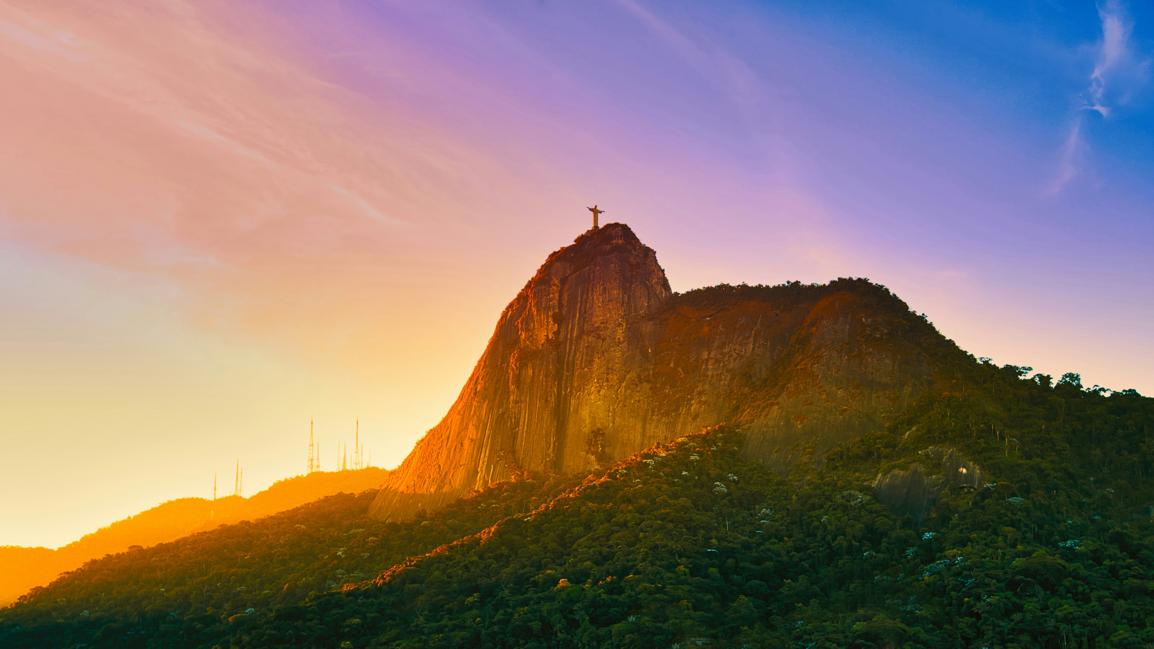 a mountain with a statue on top