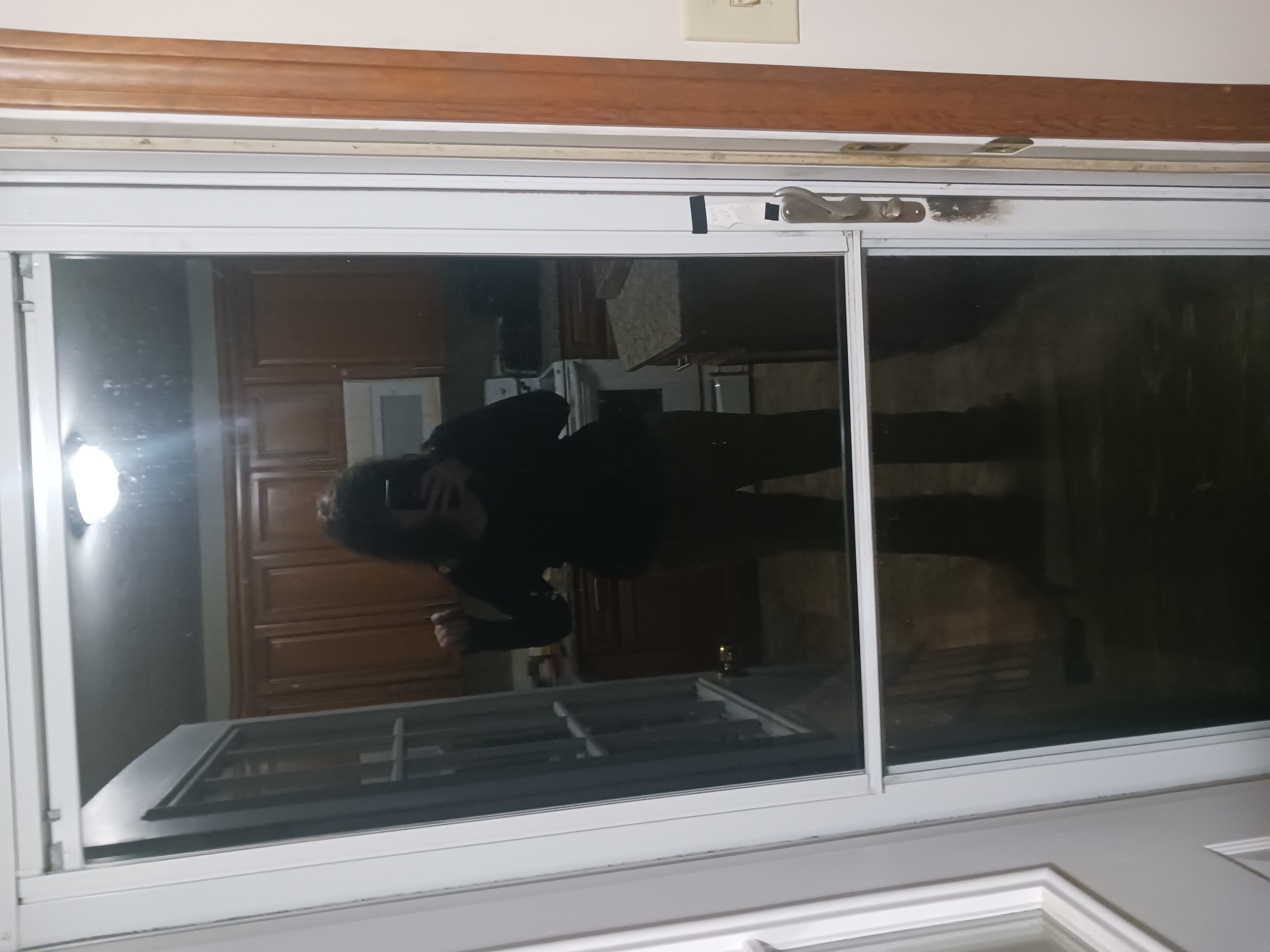 a woman taking a selfie in a kitchen