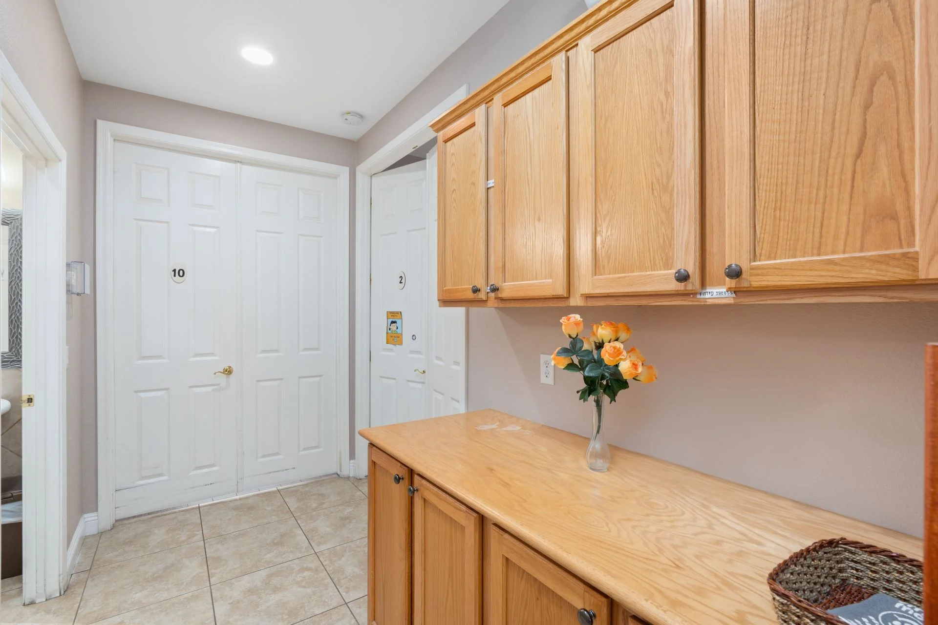 a kitchen with wood cabinets and flowers