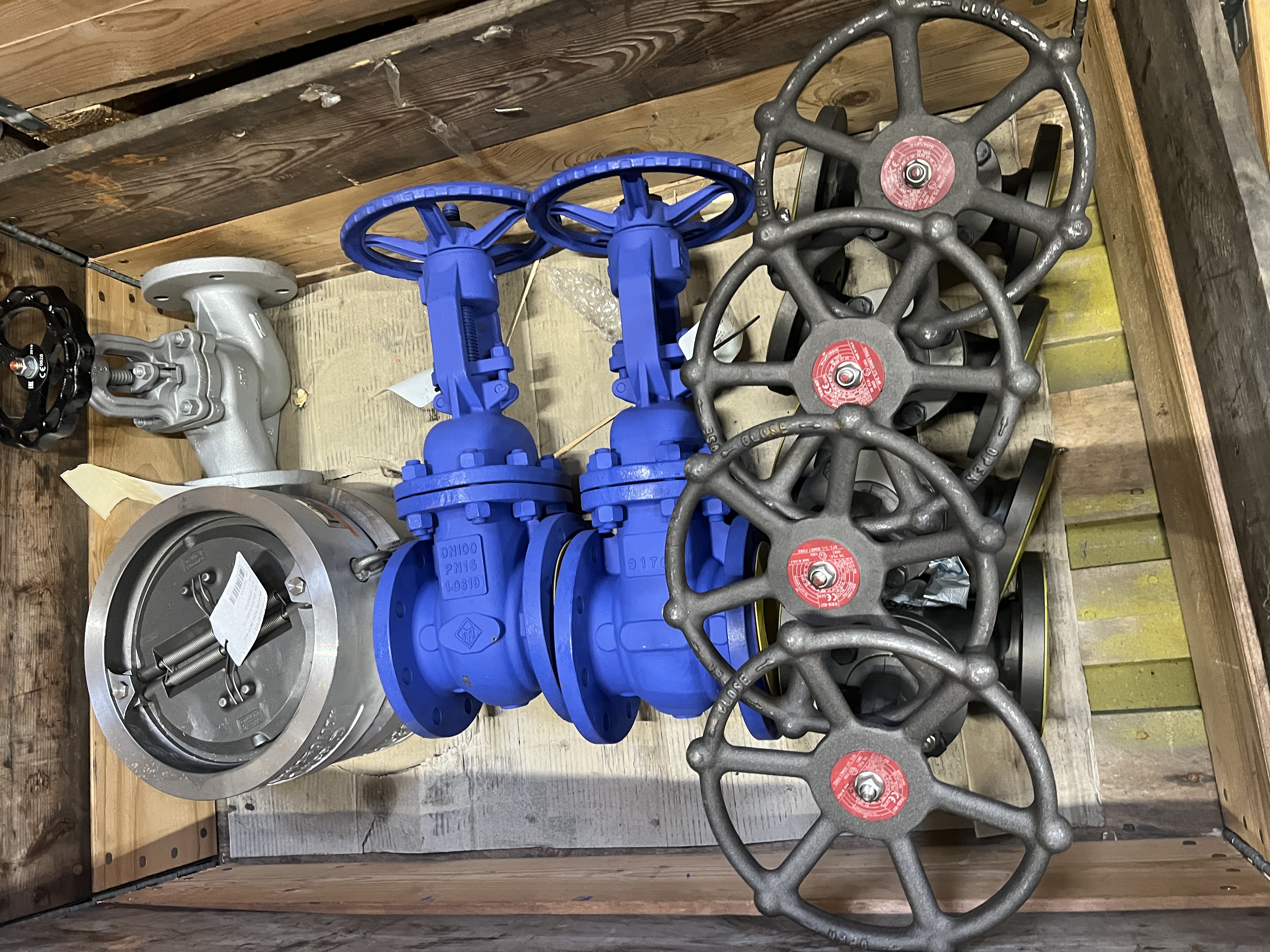 a group of blue valves in a wooden box