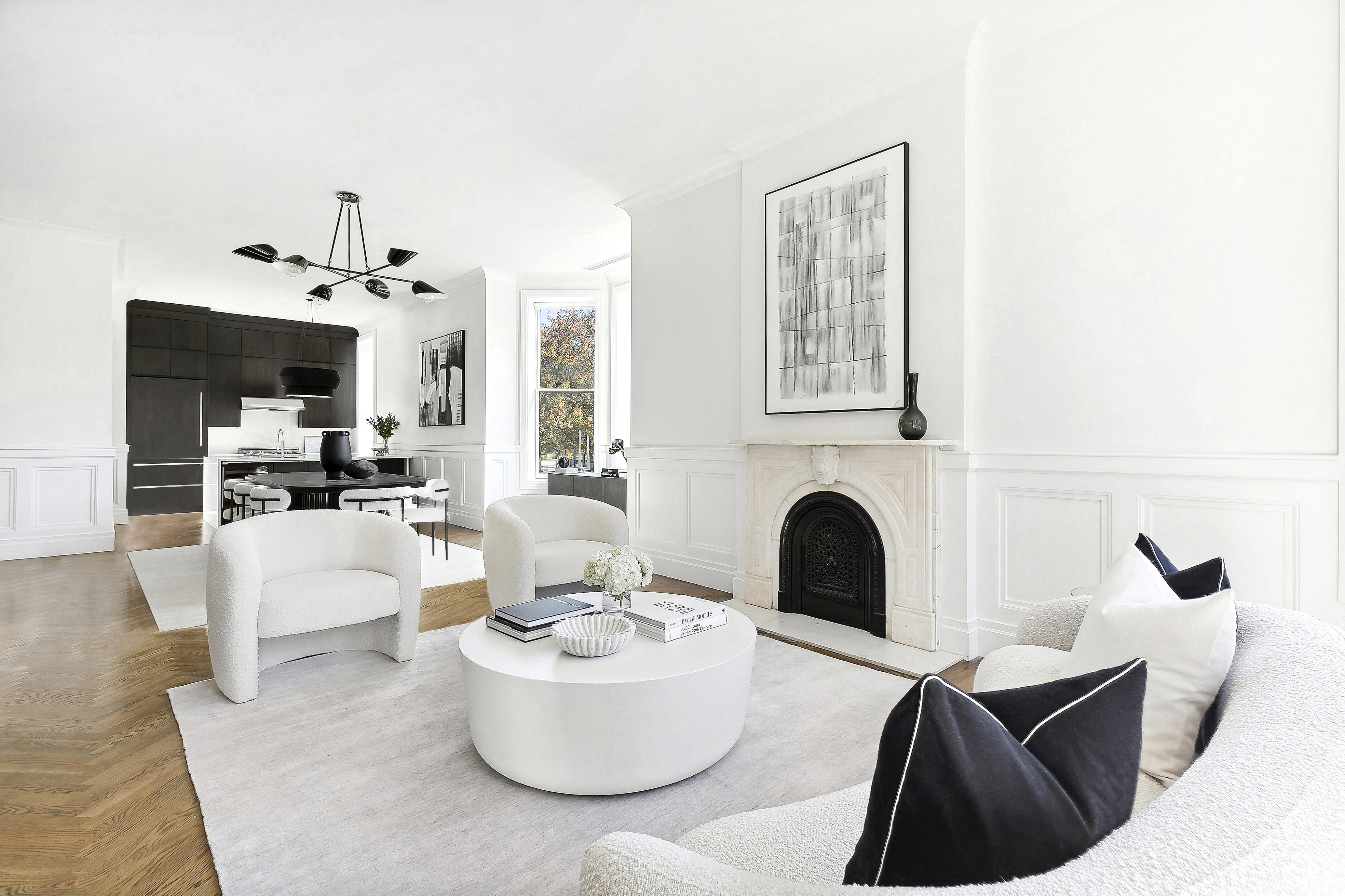 a living room with white furniture and a fireplace
