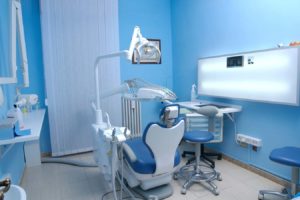 a dental chair in a blue room