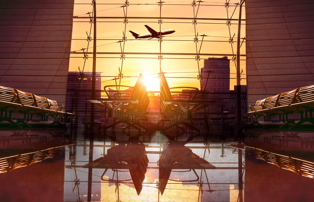 an airplane flying over a glass building