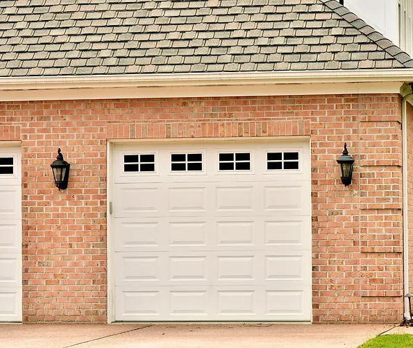 a brick garage with a white door