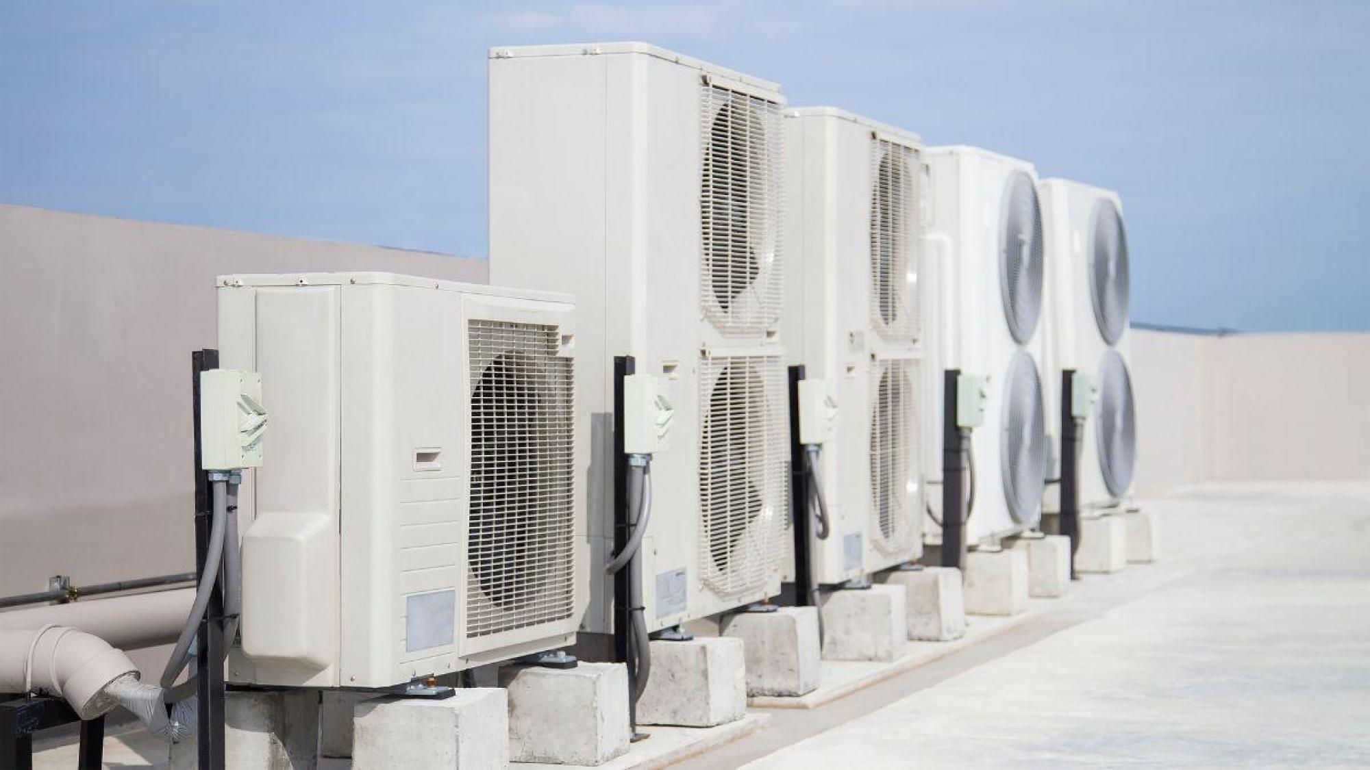 a row of white air conditioning units