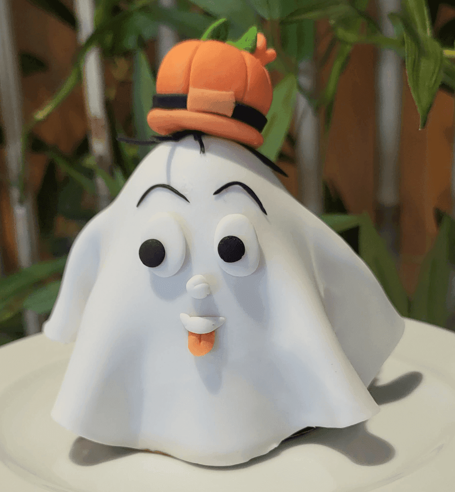 a white ghost with a hat on top of it