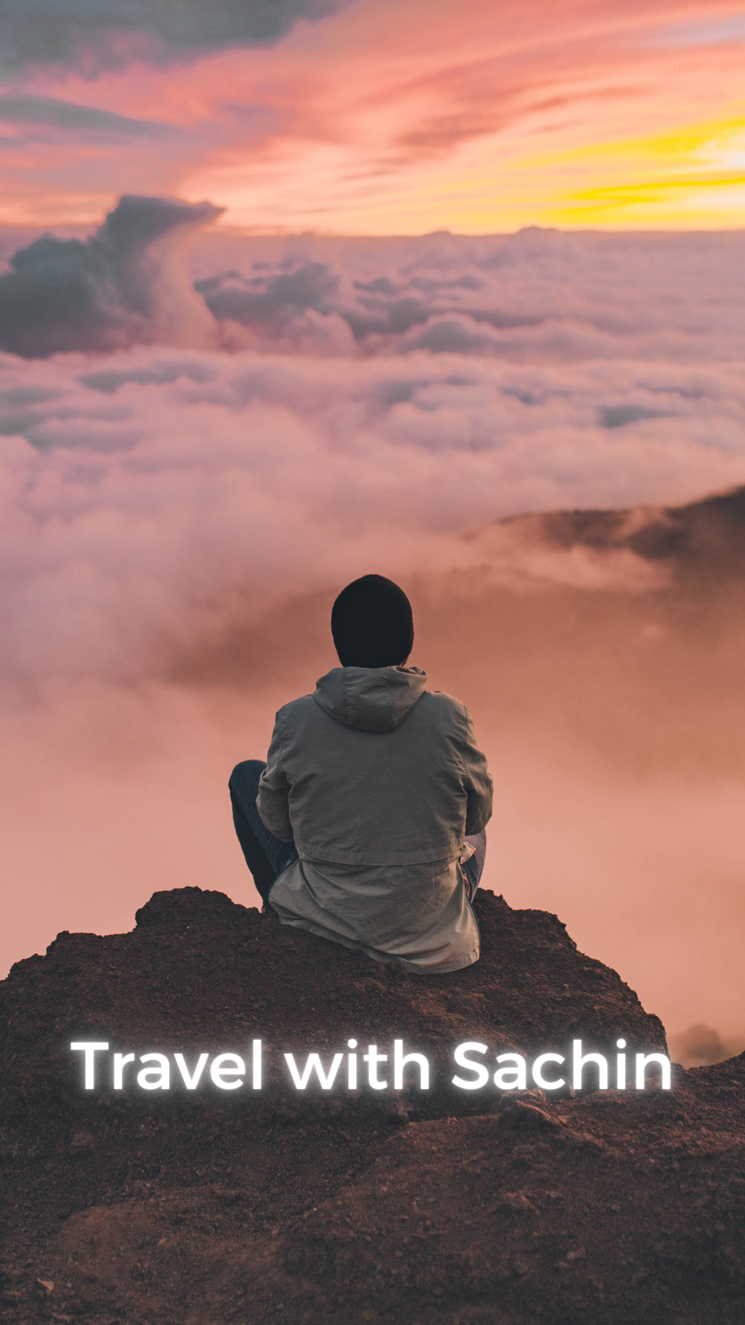 a person sitting on a rock looking at clouds