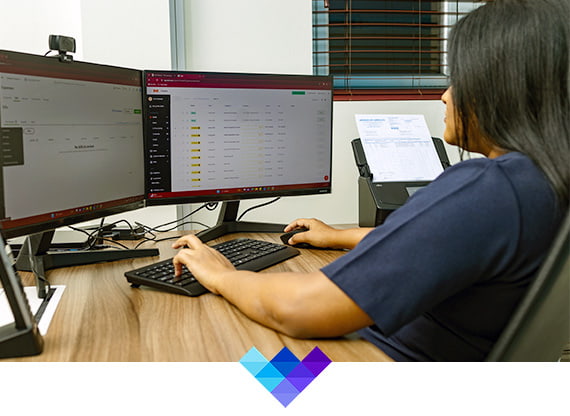 a woman sitting at a desk using a computer