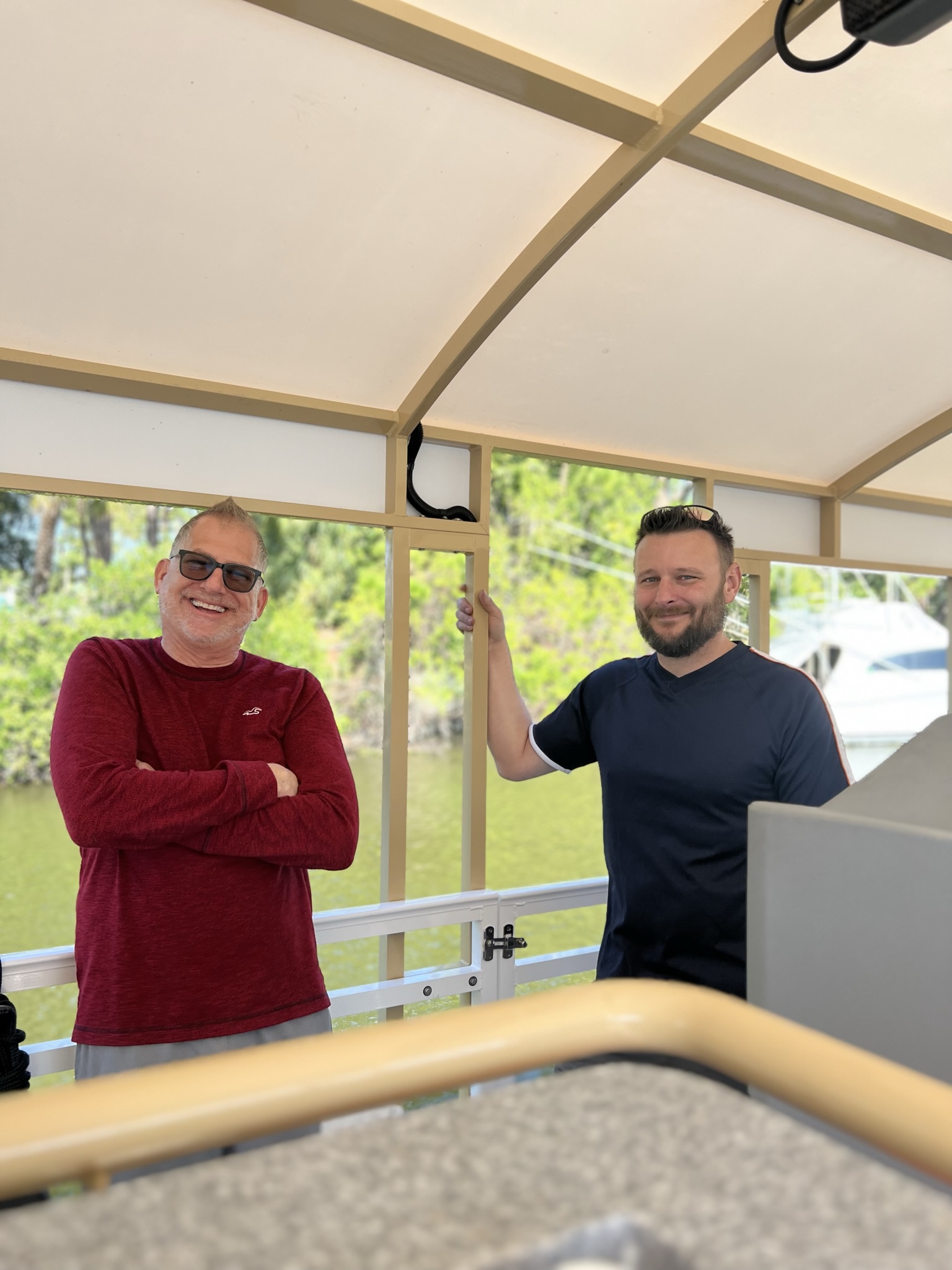 two men standing in a boat