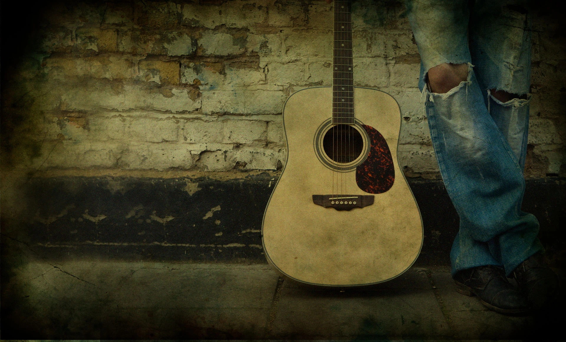 a person standing next to a guitar