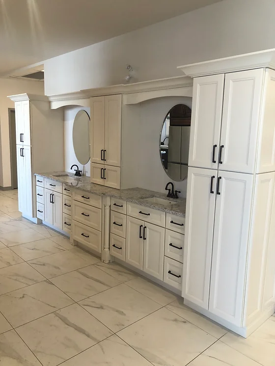 a bathroom with white cabinets and sinks