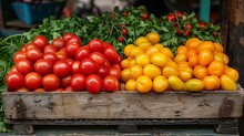 a group of tomatoes in a wooden box