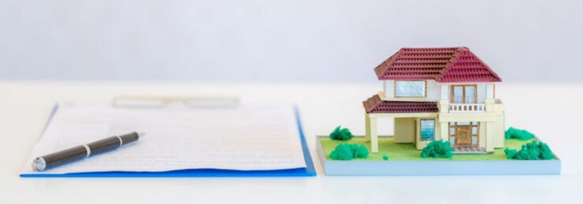 a model house next to a piece of paper