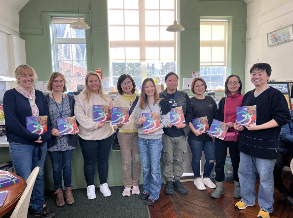 a group of people holding books