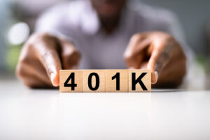 a person holding a number on a wooden block