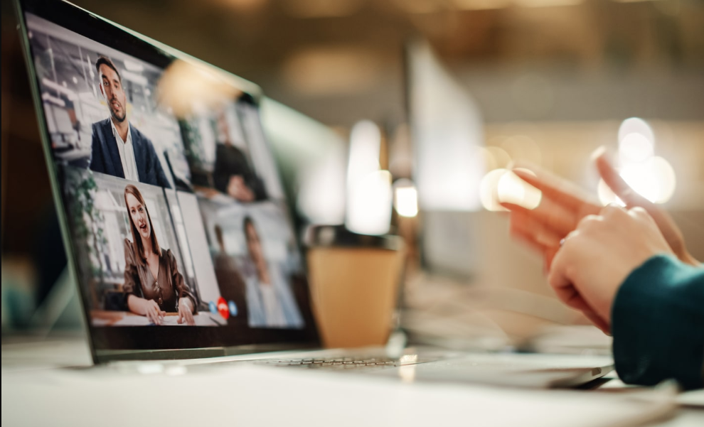 a person talking to a group of people on a laptop