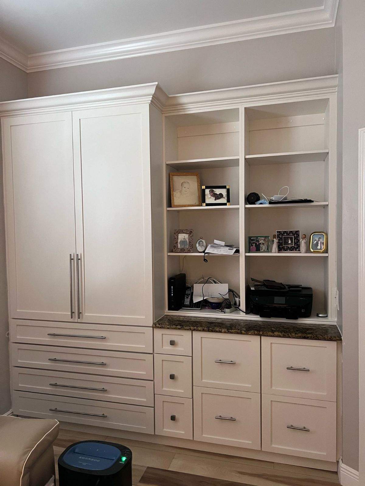 a white cabinet with shelves and a printer