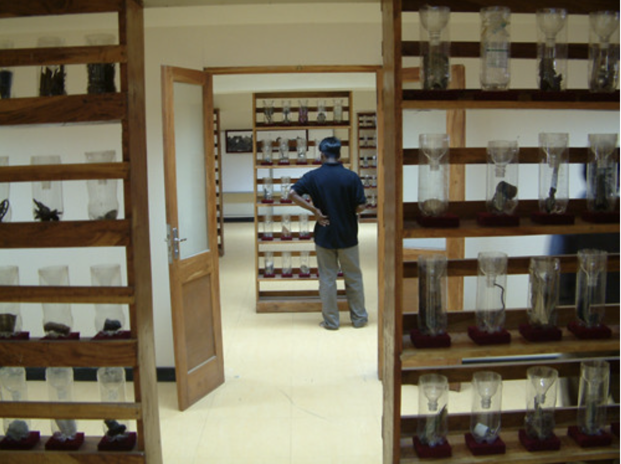 a man standing in a room with many glass objects