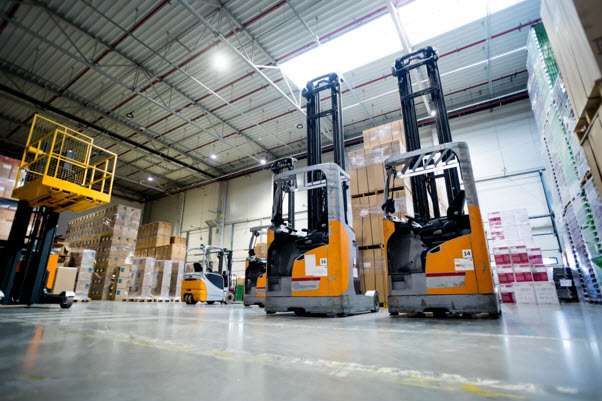 a warehouse with several forklifts