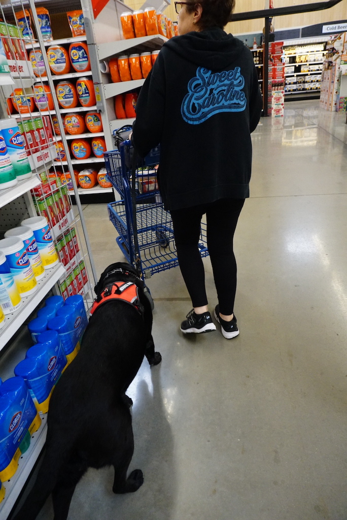 a woman with a dog in a store