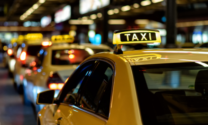 a taxi sign on top of a car