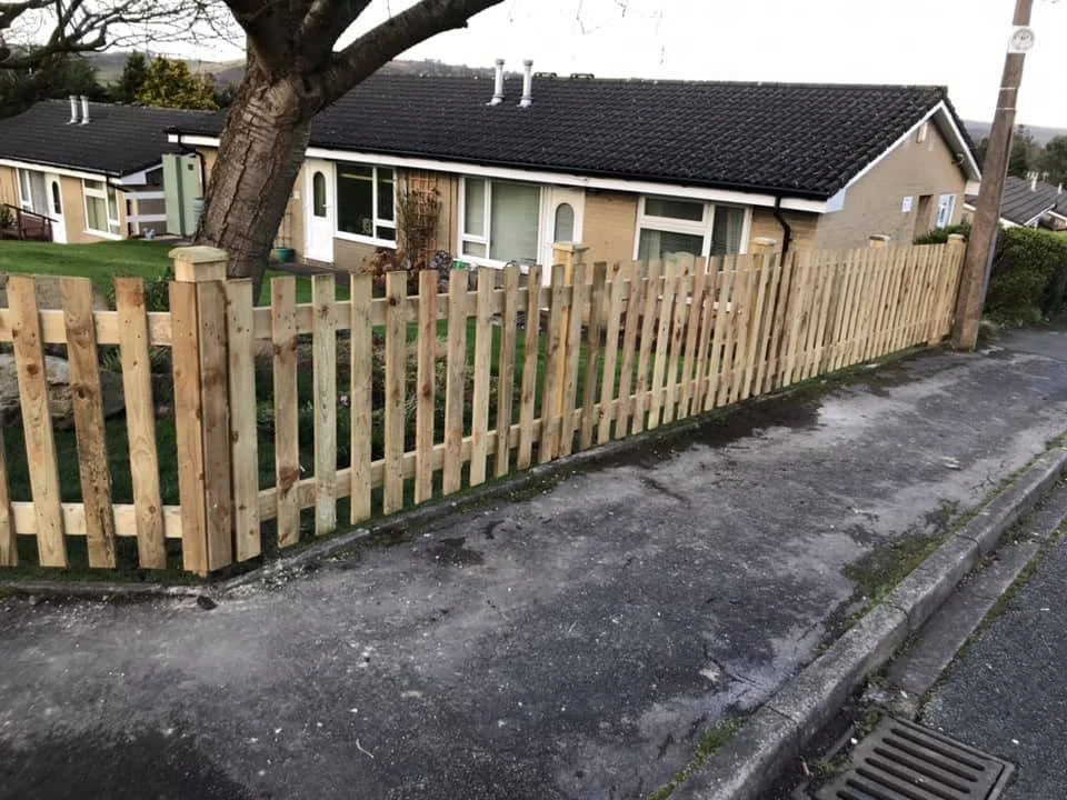 a fence next to a house