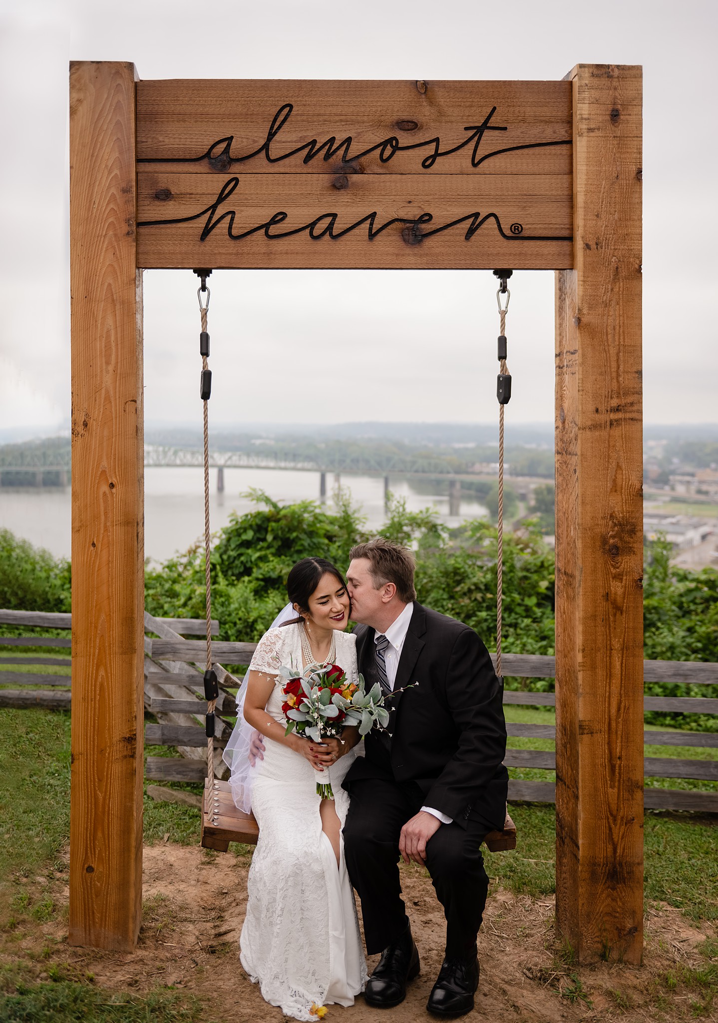 a man and woman sitting on a swing