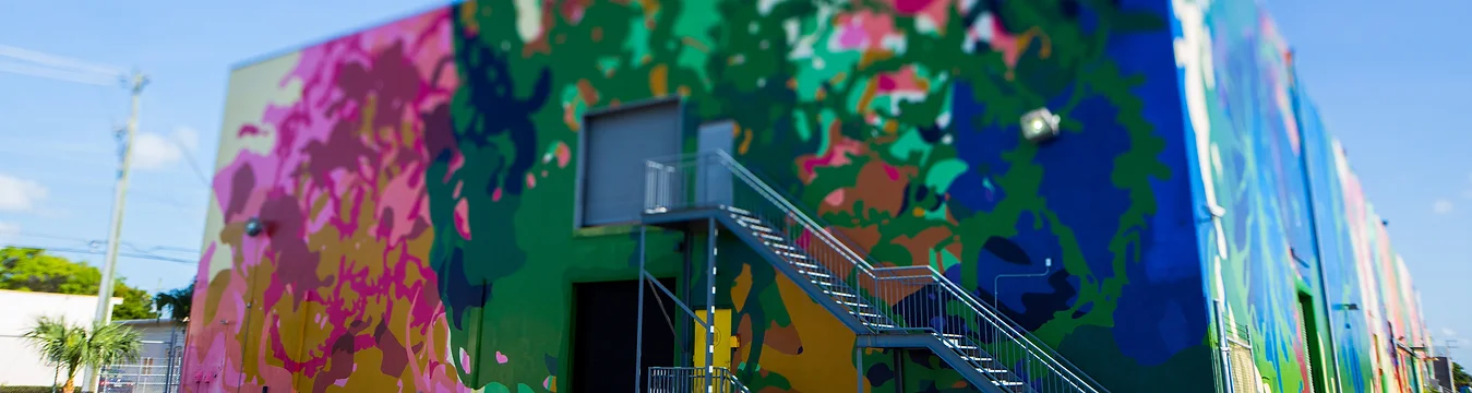 a colorful wall with a staircase