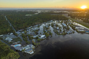 a flooded area with houses and trees