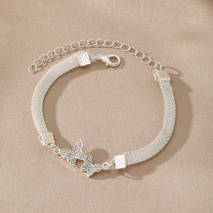 a silver bracelet with a butterfly design