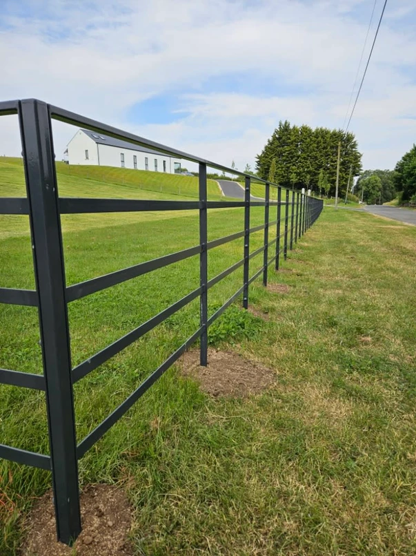 a fence along a grassy field