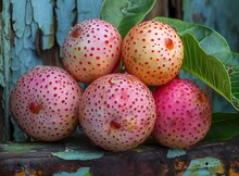 a group of round fruits with red spots