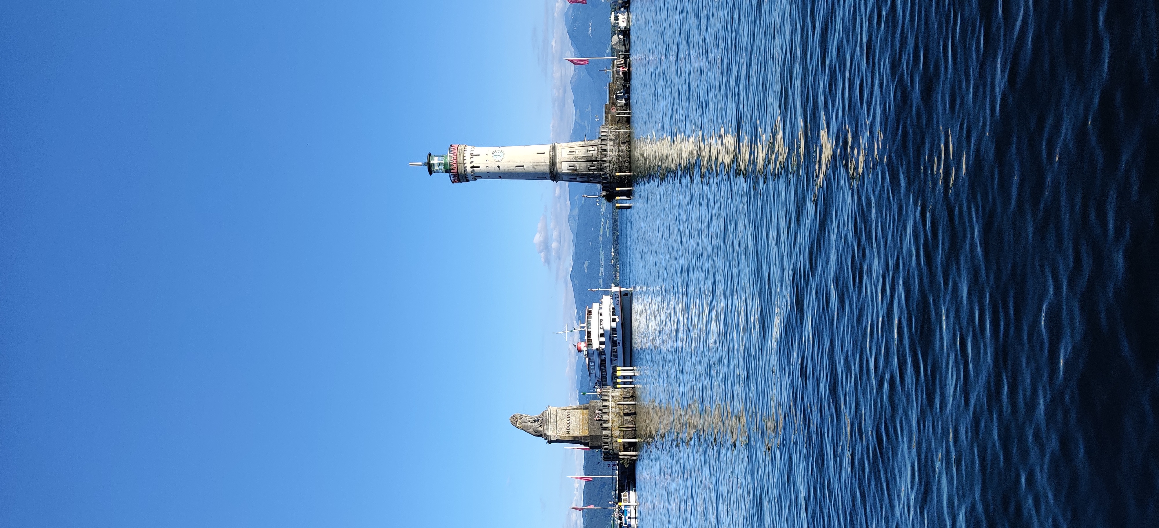 a lighthouse and boats in the water