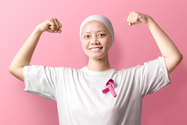 a woman wearing a white shirt and holding her arms up