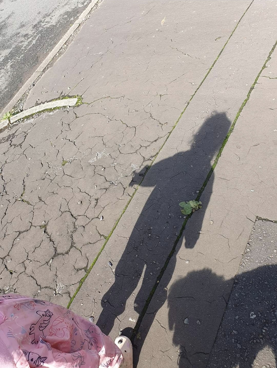 a shadow of a person on a sidewalk