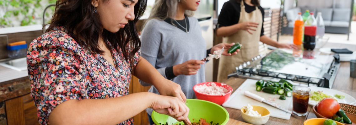 a group of people cooking in a kitchen