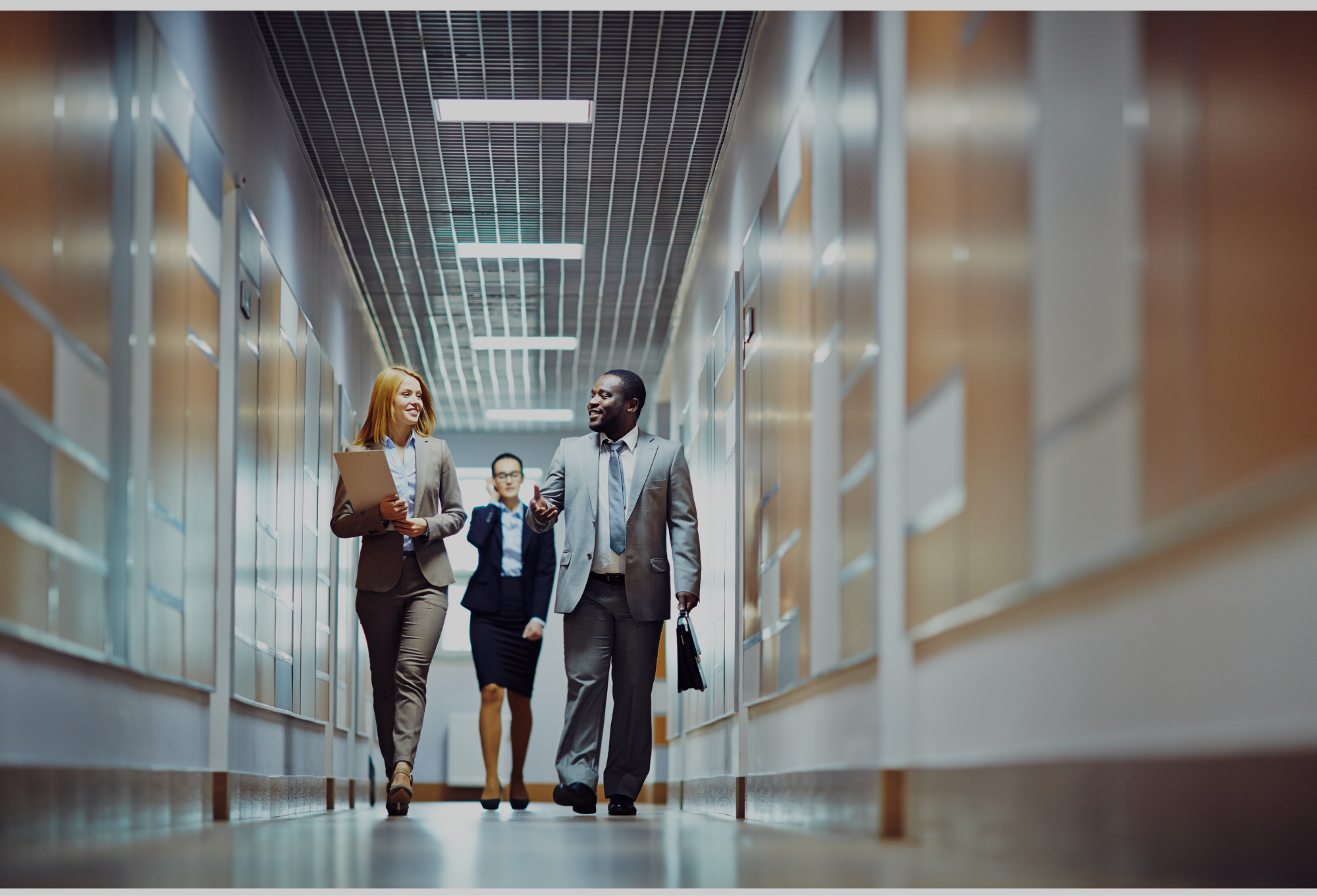 a group of people walking down a hallway