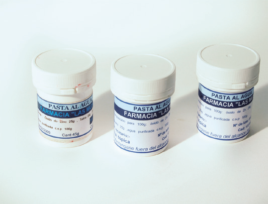 several white containers with blue labels